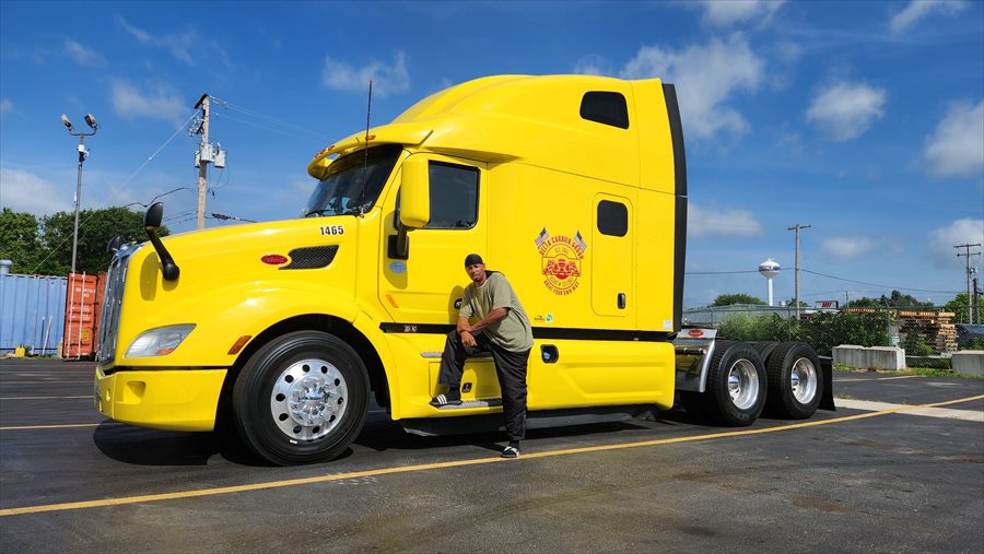 Delta Carrier Group yellow Peterbilt 579 unit 1465 yard