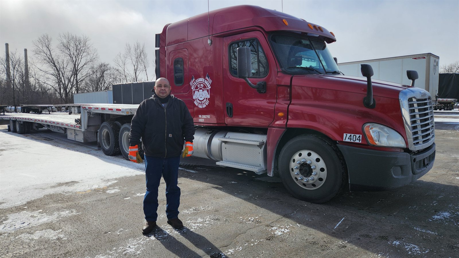 Delta owner-operator Jose Reyes with his red Freightliner Cascadia, unit 1404