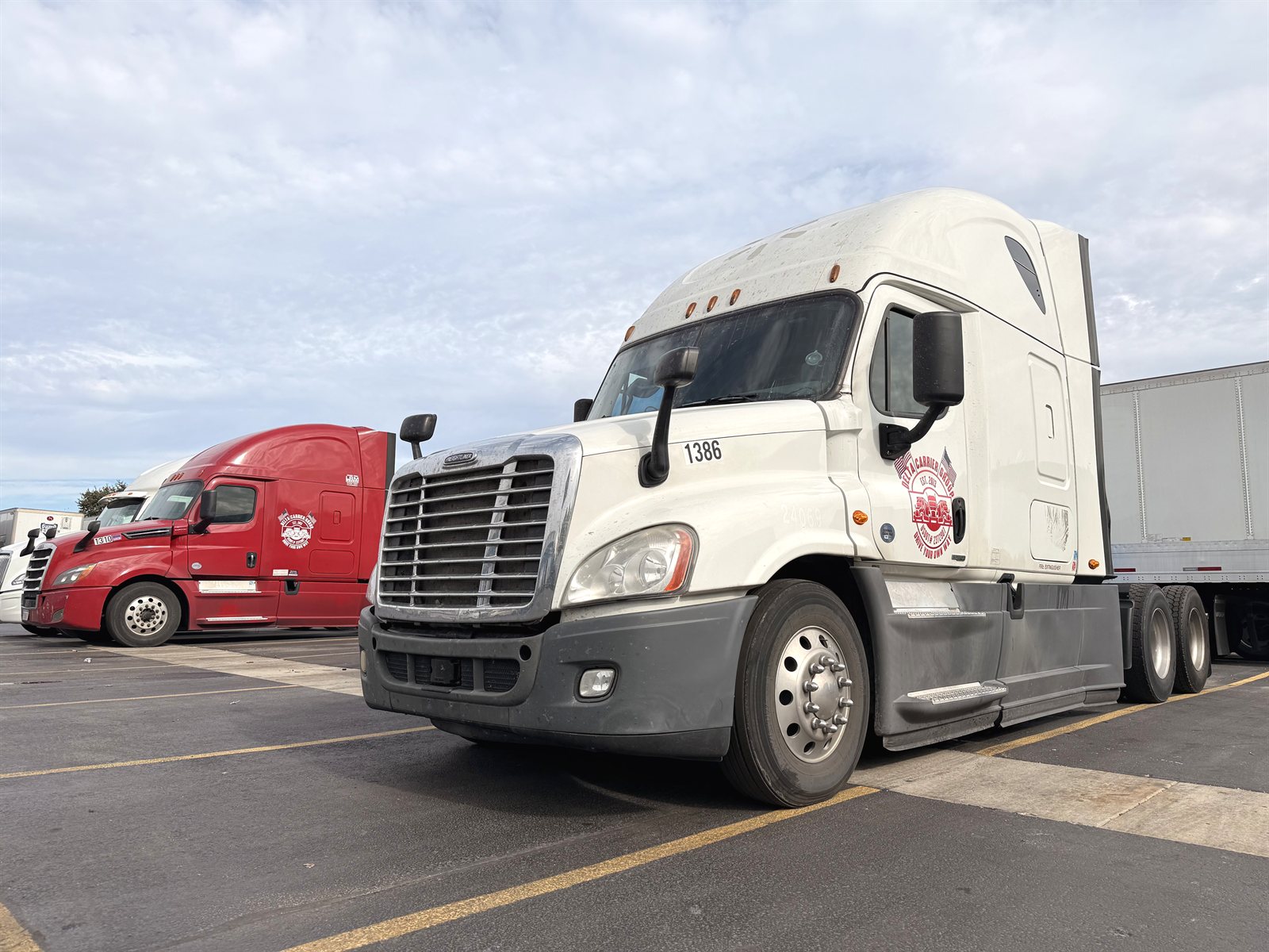 White Freightliner Cascadia with Delta door badge and dry van trailer, unit 1386