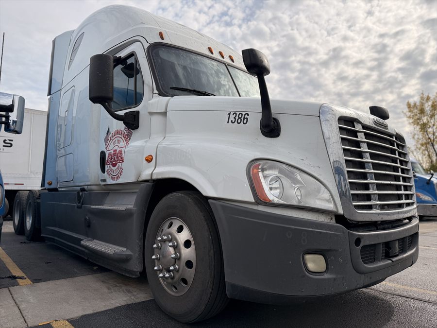 Delta Carrier Group white Freightliner Cascadia unit 1386 parking
