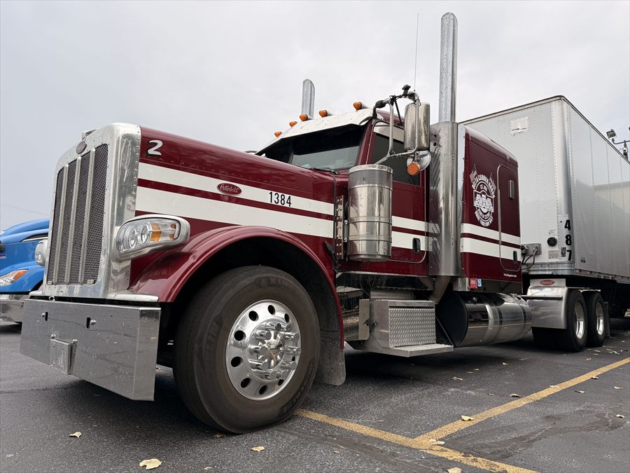 Delta Carrier Group maroon with white stripes Peterbilt 389 unit 1384 parking
