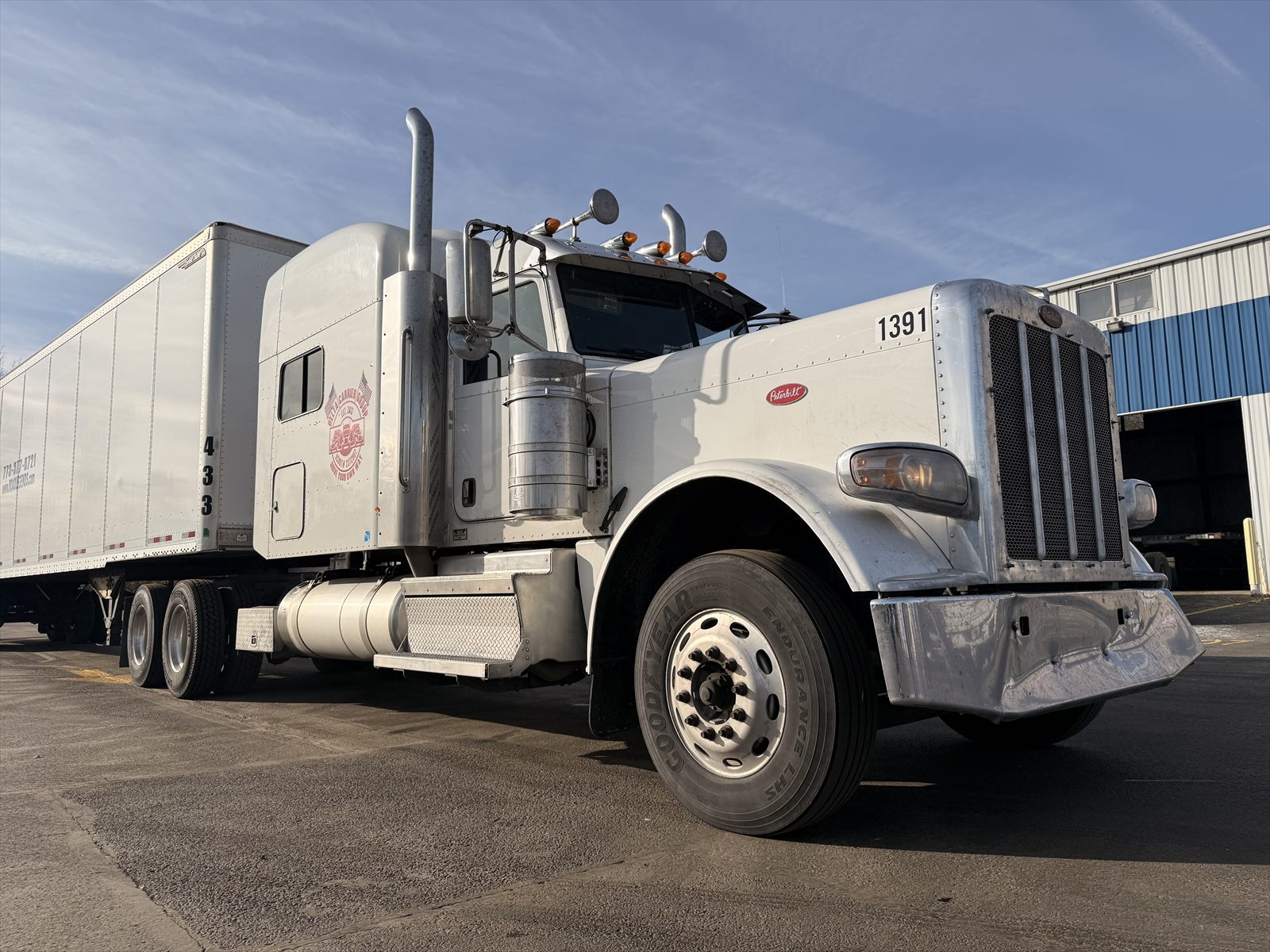 Delta Carrier Group white Peterbilt 389, unit 1391, coupled to a dry van trailer