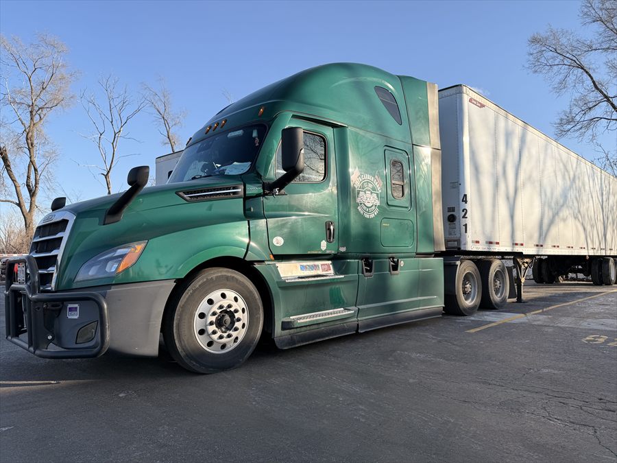 Delta Carrier Group green Freightliner Cascadia parking