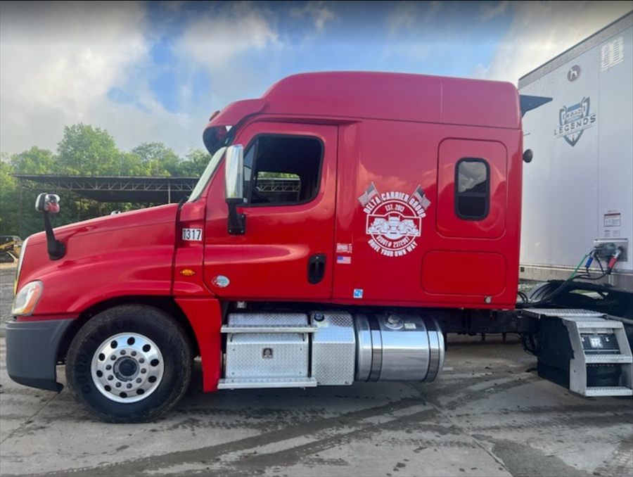 Delta Carrier Group red Freightliner Cascadia (prev-gen) unit 1317 yard