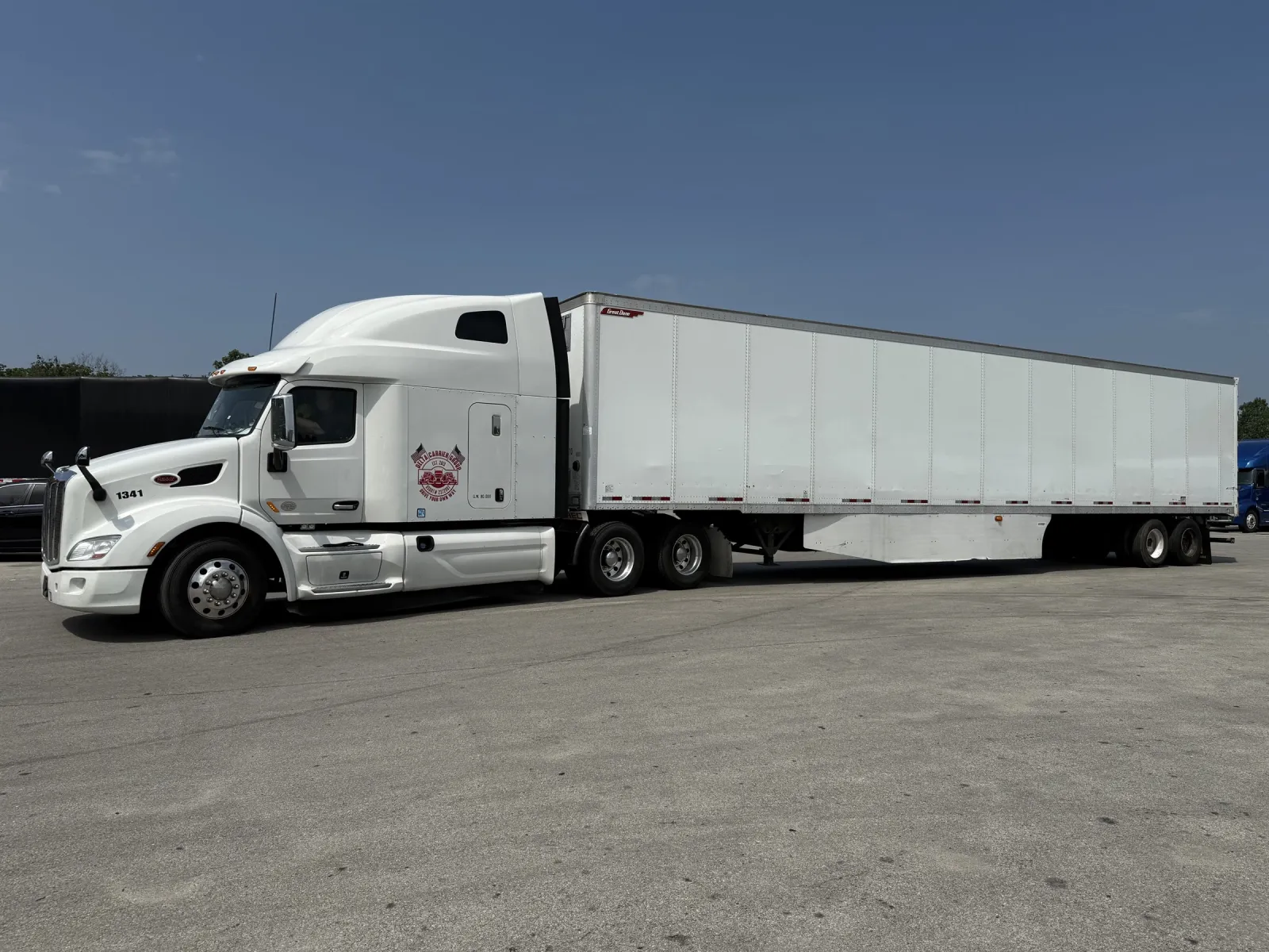 White Peterbilt 579 with Delta badge pulling a dry van trailer, unit 1341